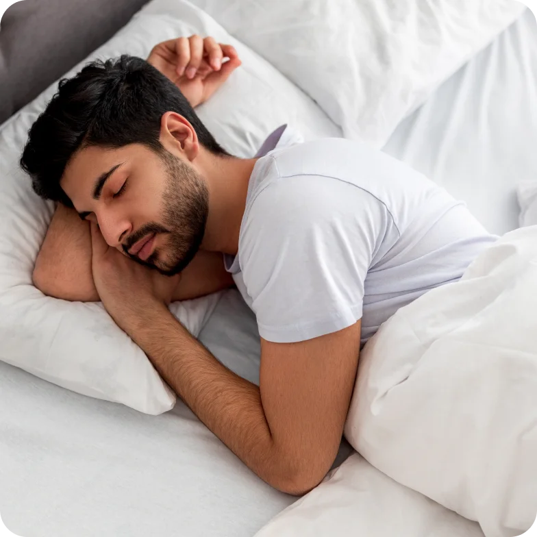 Asleep young man sleeping, resting peacefully in comfortable bed, lying with closed eyes.
